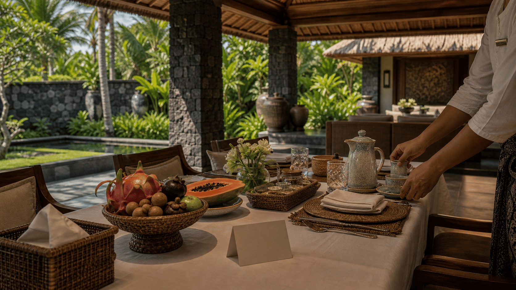 Bali Dry Season Villas shown as Bali pavilion breakfast prep before guests for VIAIVE, with linen breakfast, volcanic stone, woven craft.