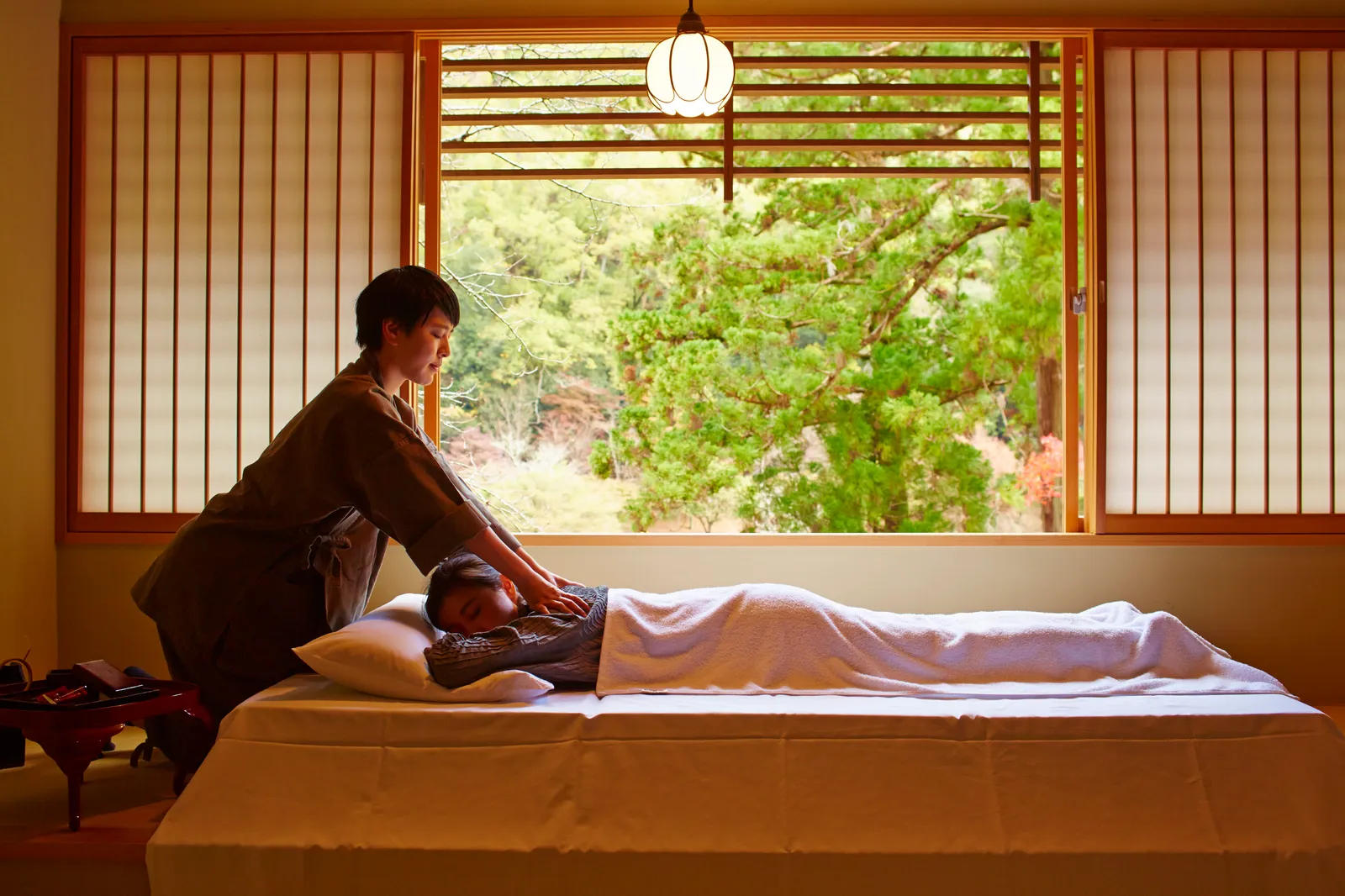 A spa treatment at HOSHINOYA Kyoto in a traditional room overlooking the garden.