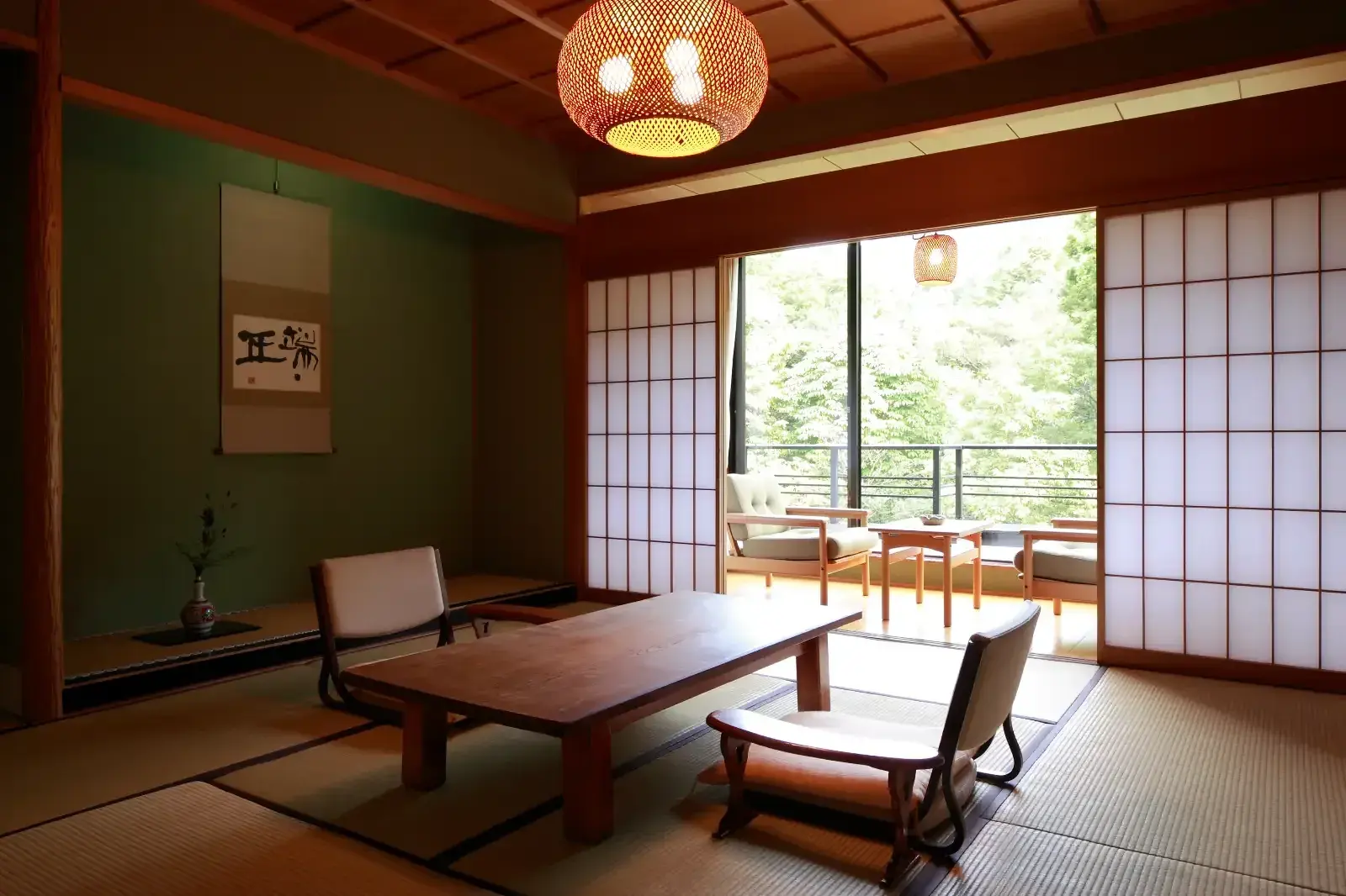 A Kayotei tatami guest room opening toward the forest view.