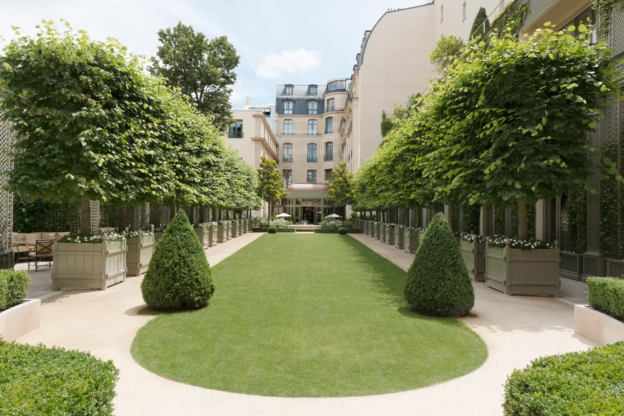 The Grand Jardin garden courtyard in summer at Le Ritz Paris, Place Vendôme
