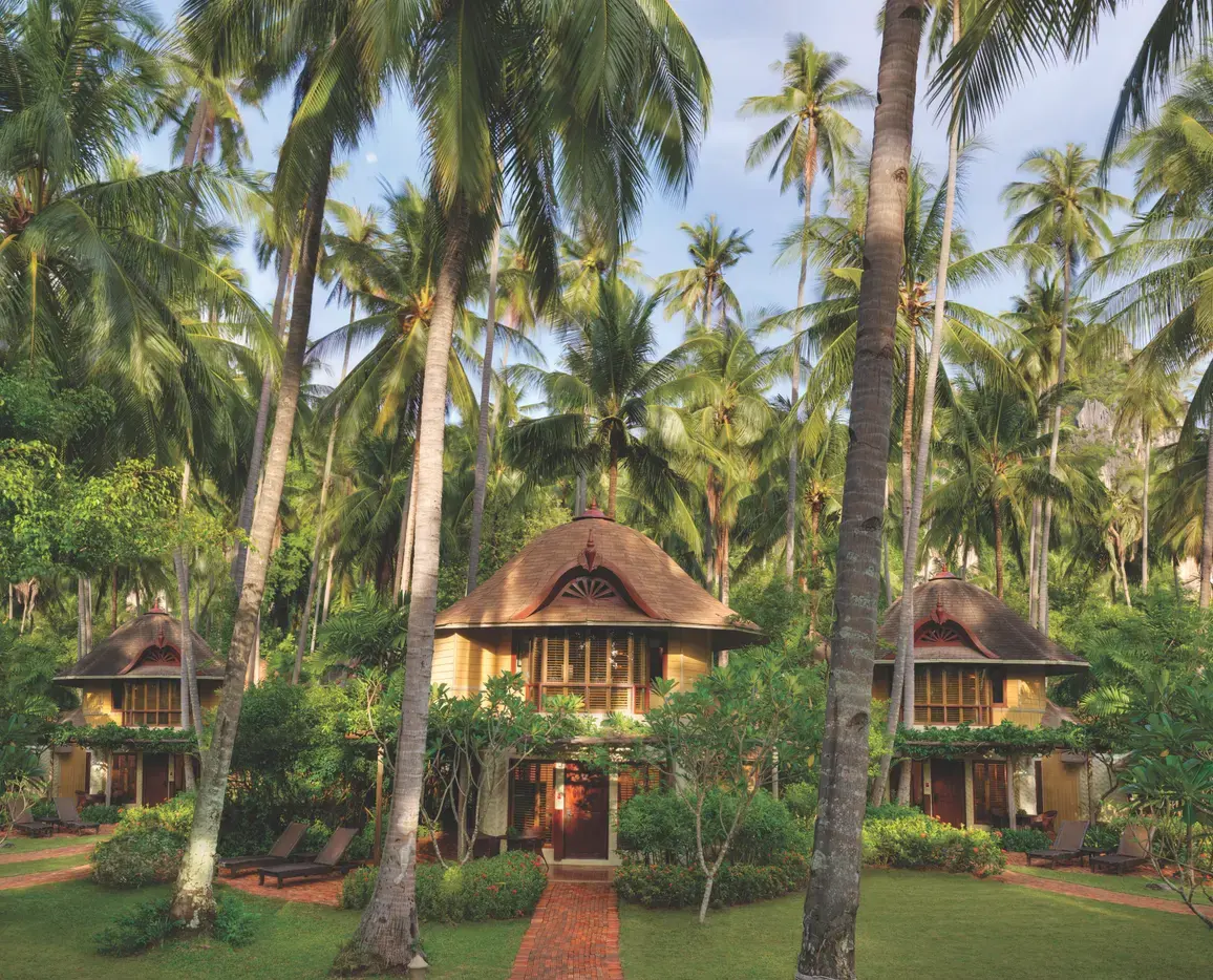 Deluxe Pavilion exterior set among palm trees at Rayavadee