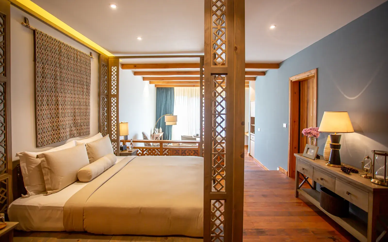 Guest suite bedroom at Bhutan Spirit Sanctuary with Bhutanese textile accents and a garden-facing balcony