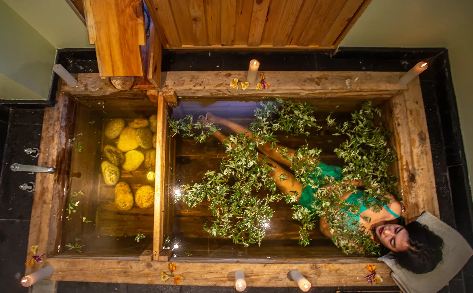 Traditional Bhutanese hot stone bath treatment with herbs and candlelight at Bhutan Spirit Sanctuary
