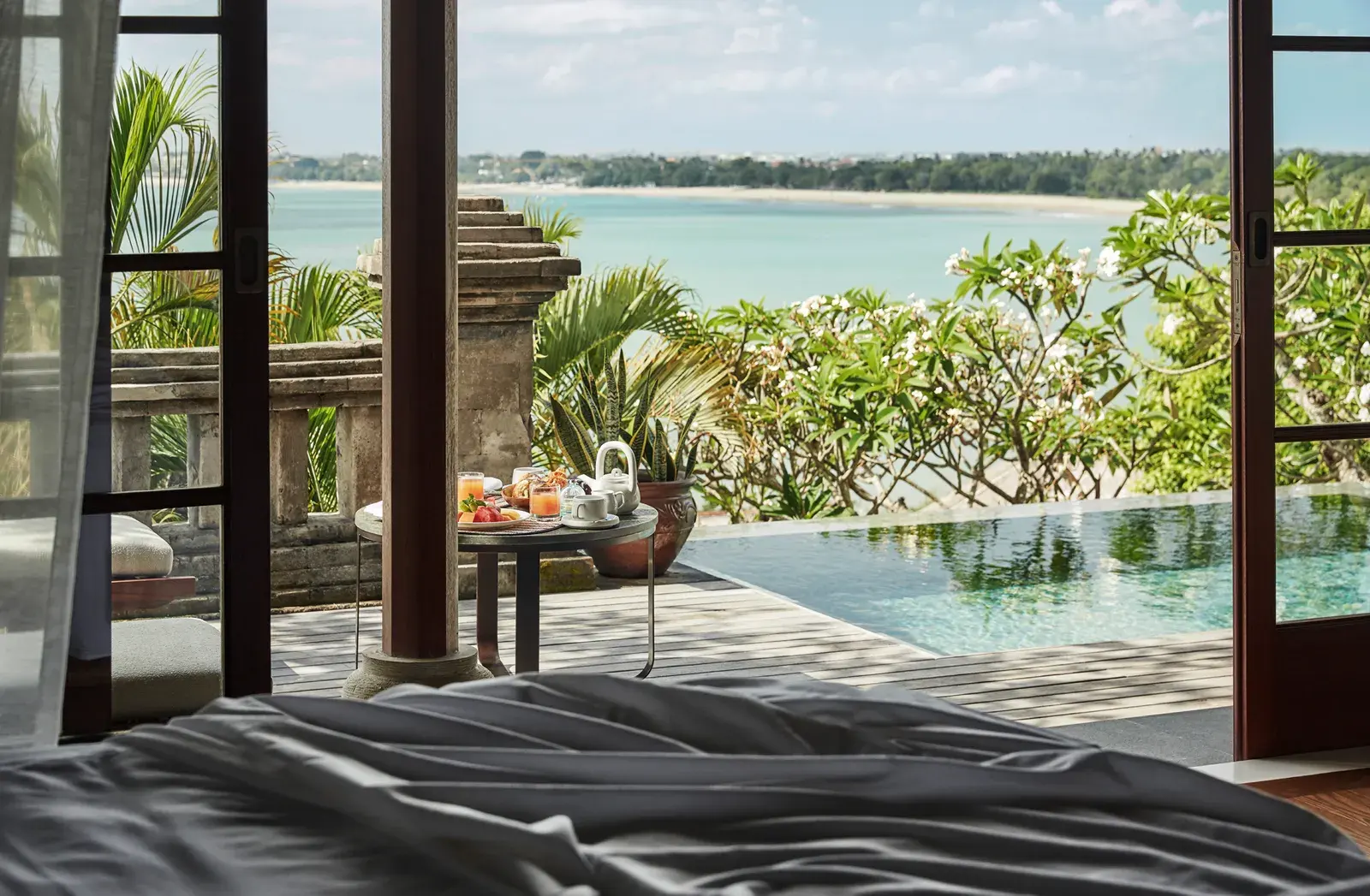 Dining terrace overlooking the pool and ocean at Four Seasons Bali at Jimbaran Bay