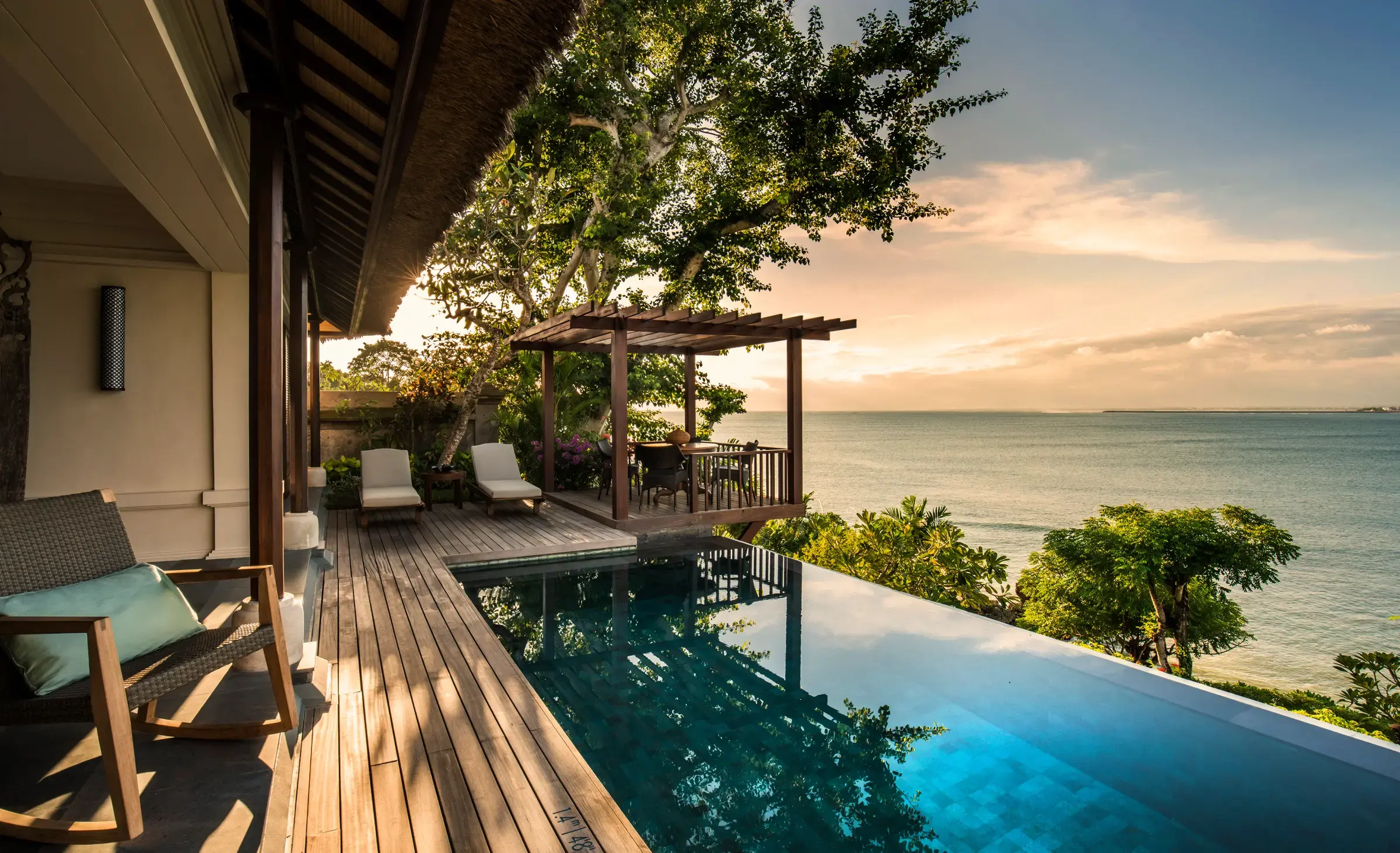 Private villa pool at Four Seasons Bali at Jimbaran Bay overlooking the ocean at sunset