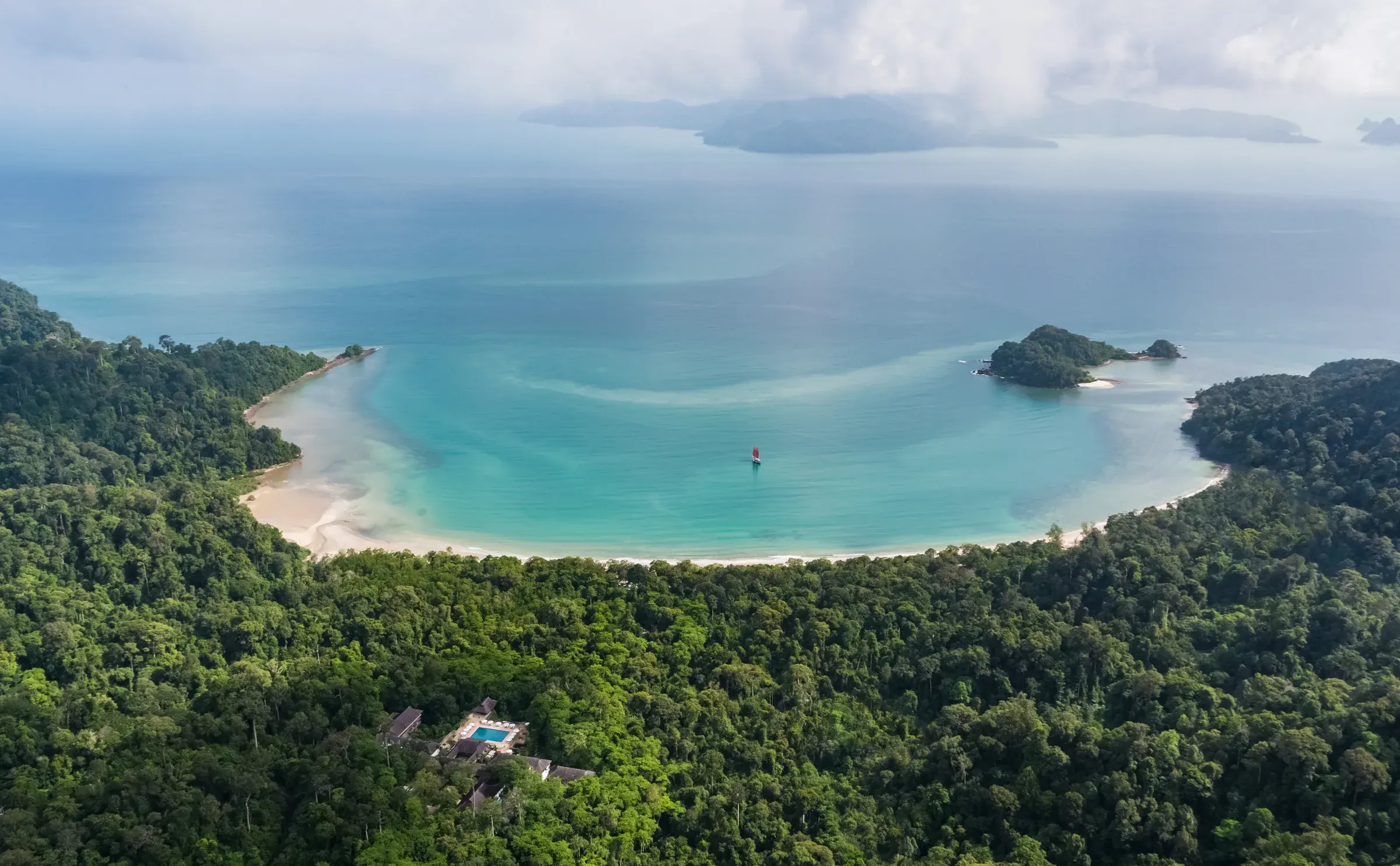 Aerial view of The Datai Langkawi resort nestled in ancient rainforest above the Andaman Sea