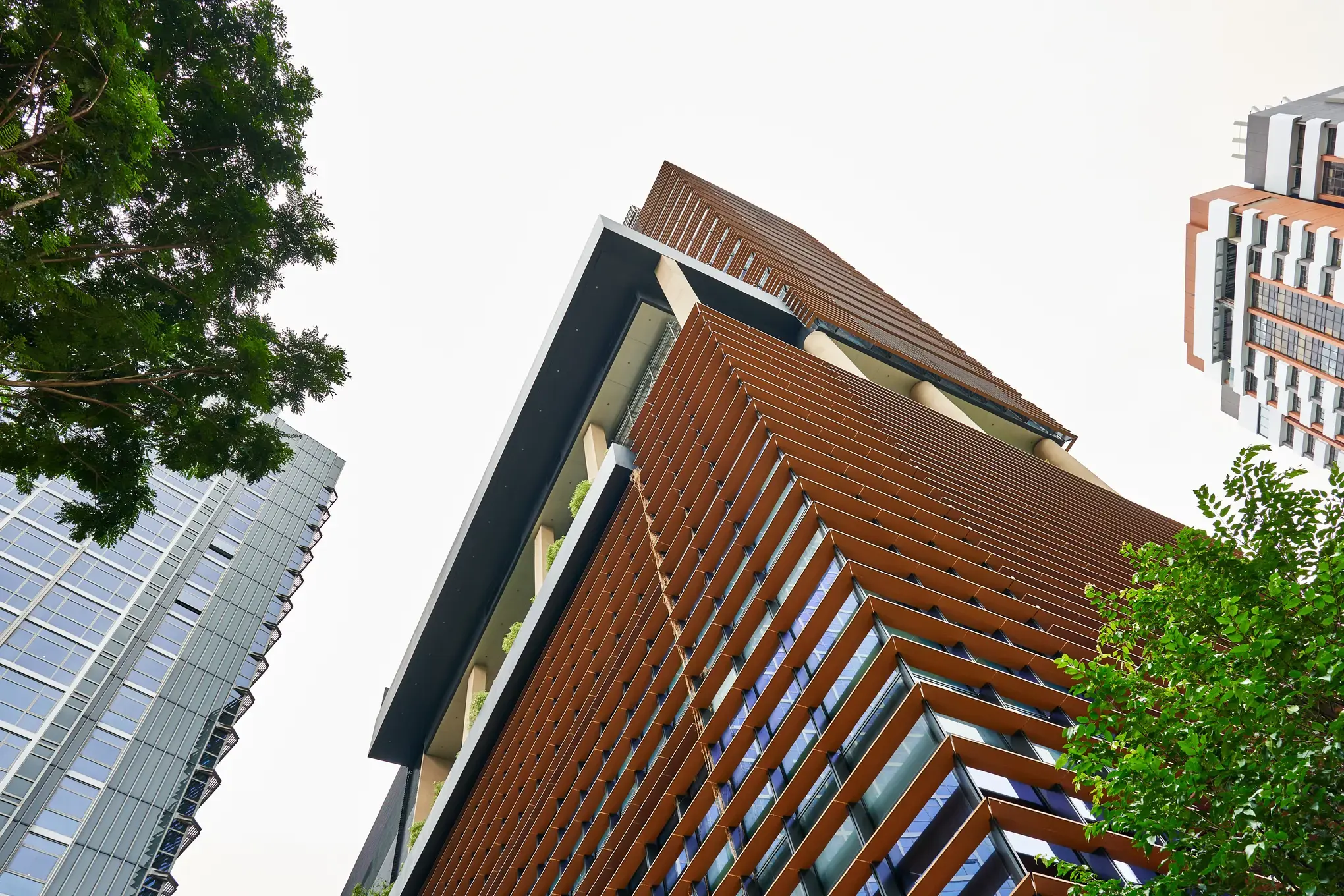 Upward angle of COMO Metropolitan Singapore's copper-toned facade