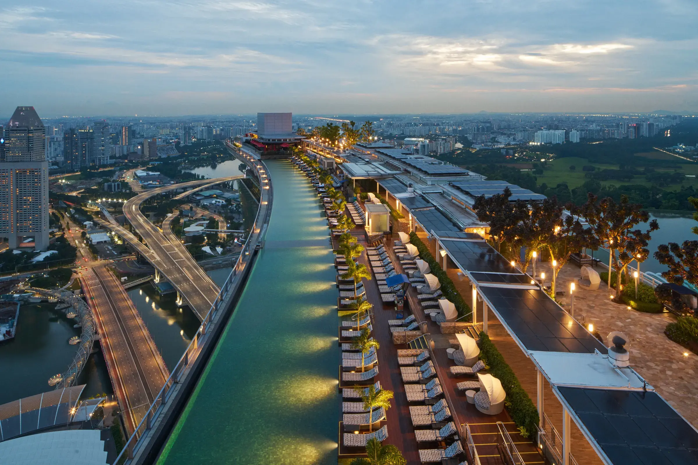 Marina Bay Sands' rooftop infinity pool at dusk, an aerial view of the SkyPark.