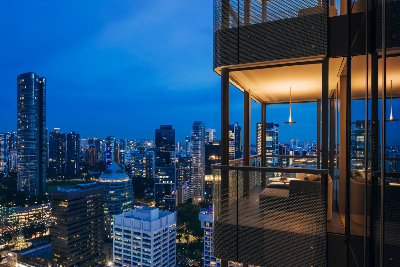 Suite balcony with Singapore skyline view at night at Pan Pacific Orchard