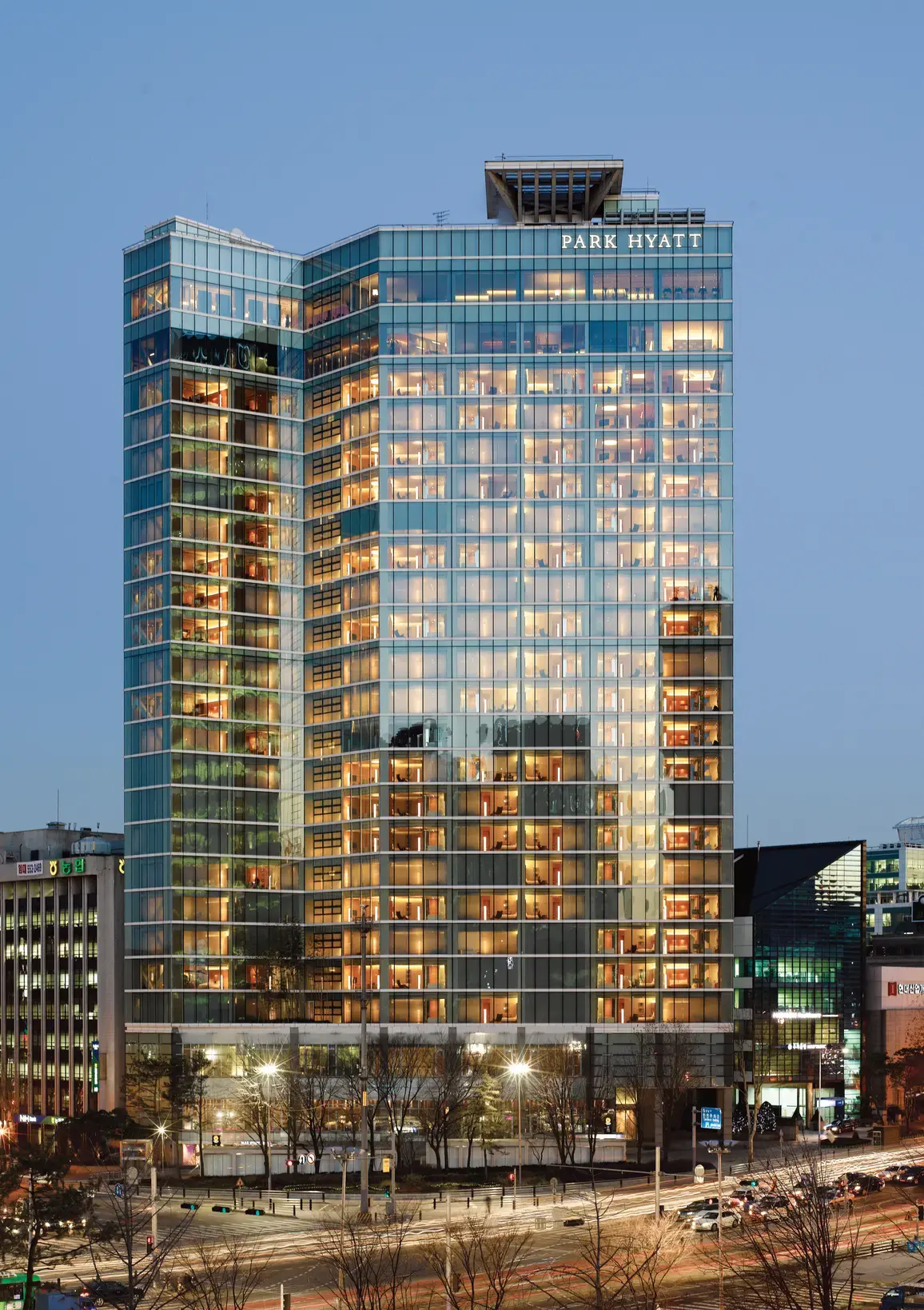 Park Hyatt Seoul tower illuminated above the Gangnam streets at blue hour