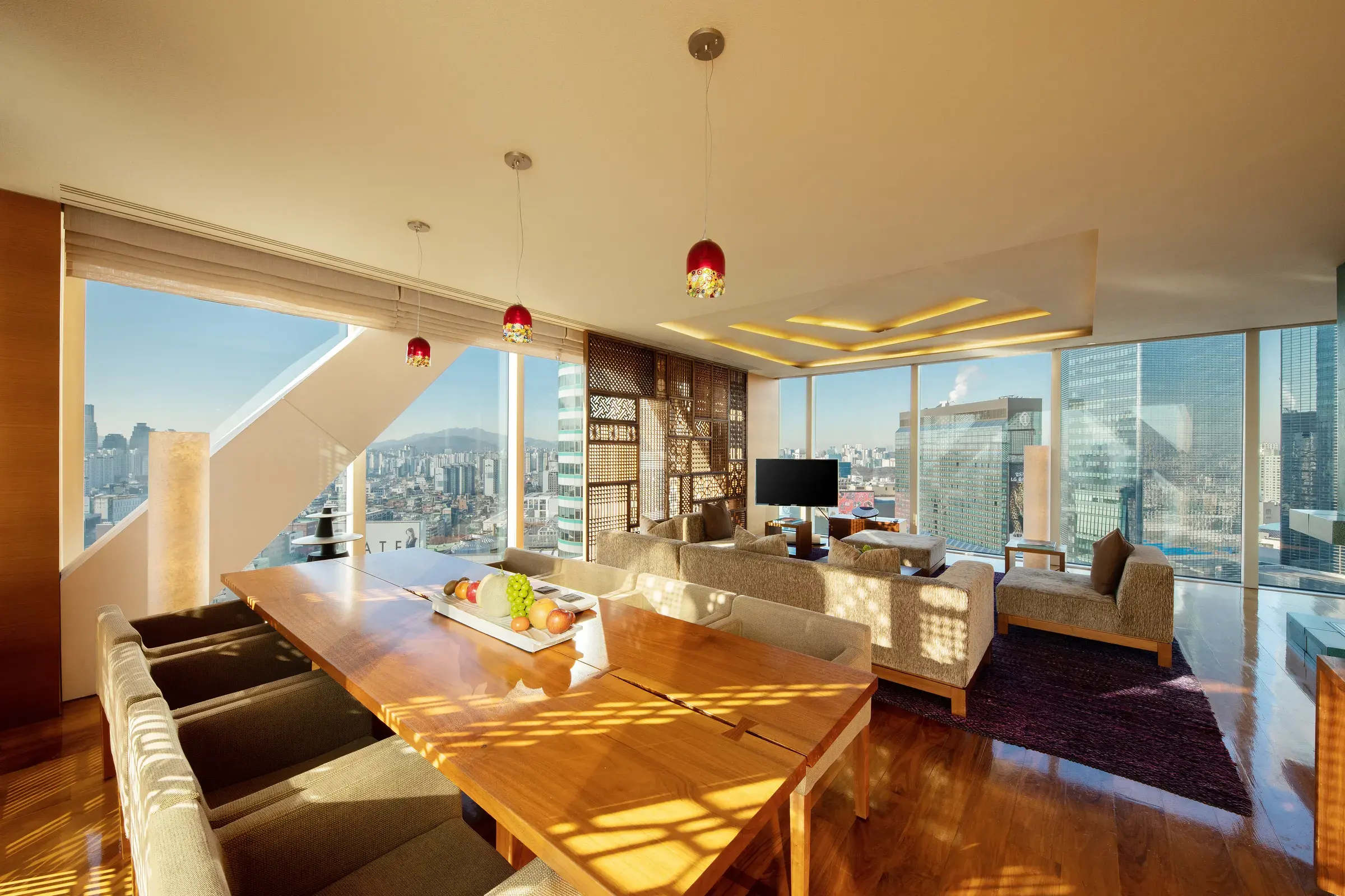 Sunlit presidential suite living and dining area overlooking Seoul at Park Hyatt Seoul