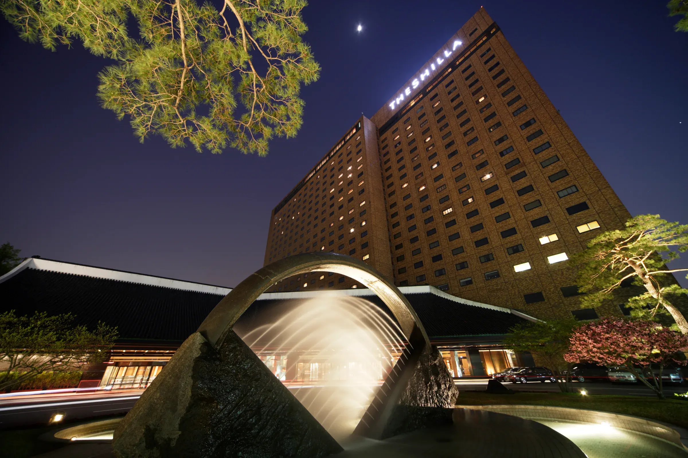 The Shilla Seoul exterior at night with its illuminated entrance and fountain
