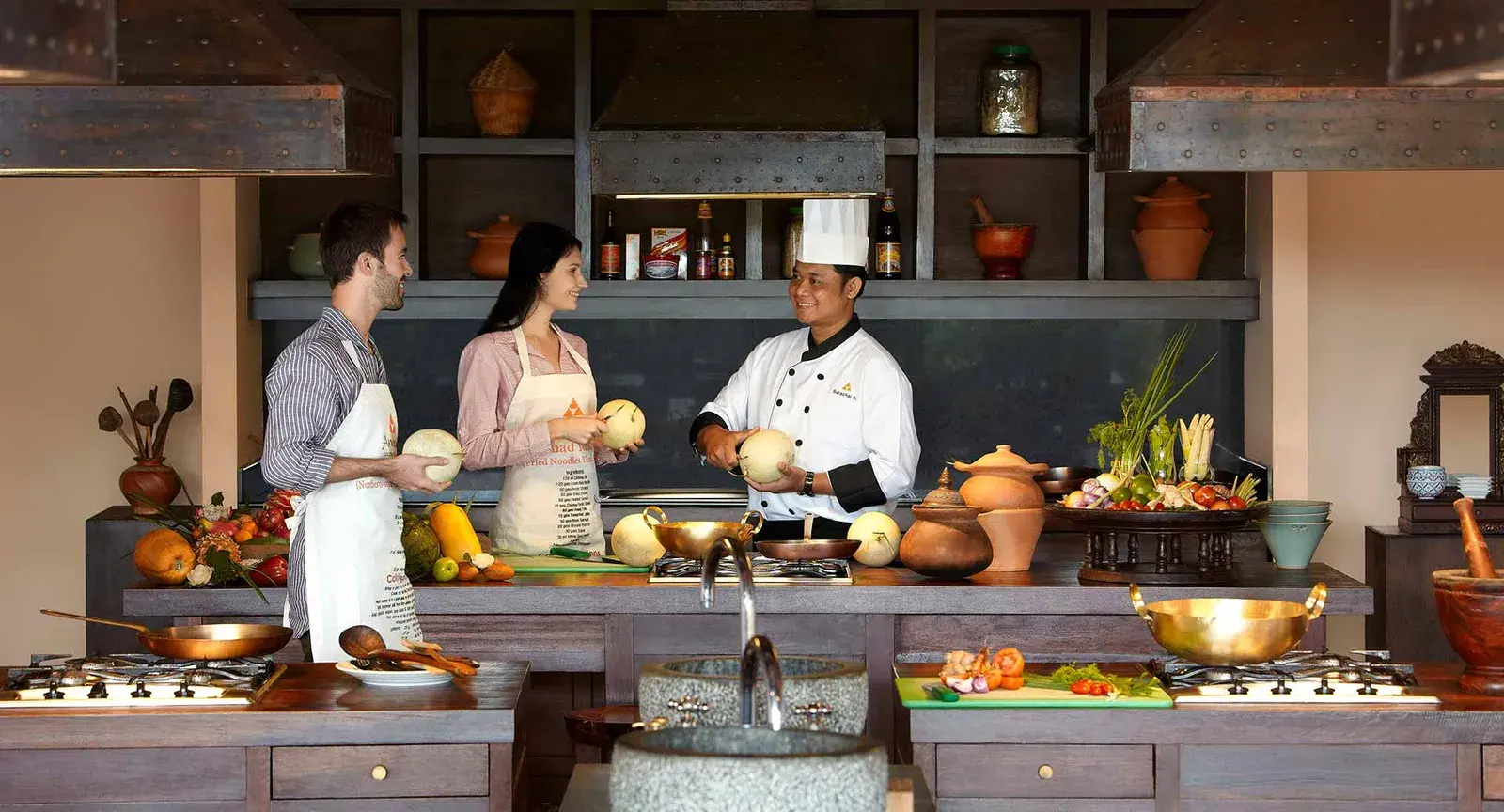 Guests in a Spice Spoons cooking class at Anantara Golden Triangle Elephant Camp & Resort