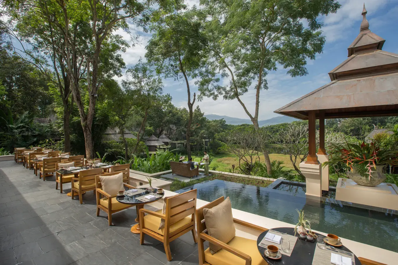Outdoor dining terrace overlooking rice paddies at Four Seasons Resort Chiang Mai