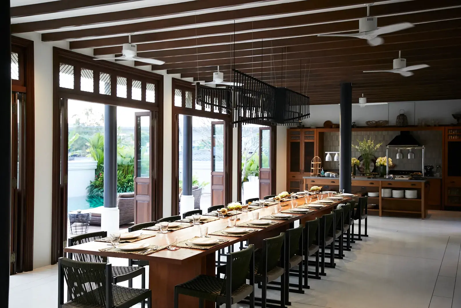 Heritage teak dining table on the villa's old floorboards at Siri Sala Private Thai Villa
