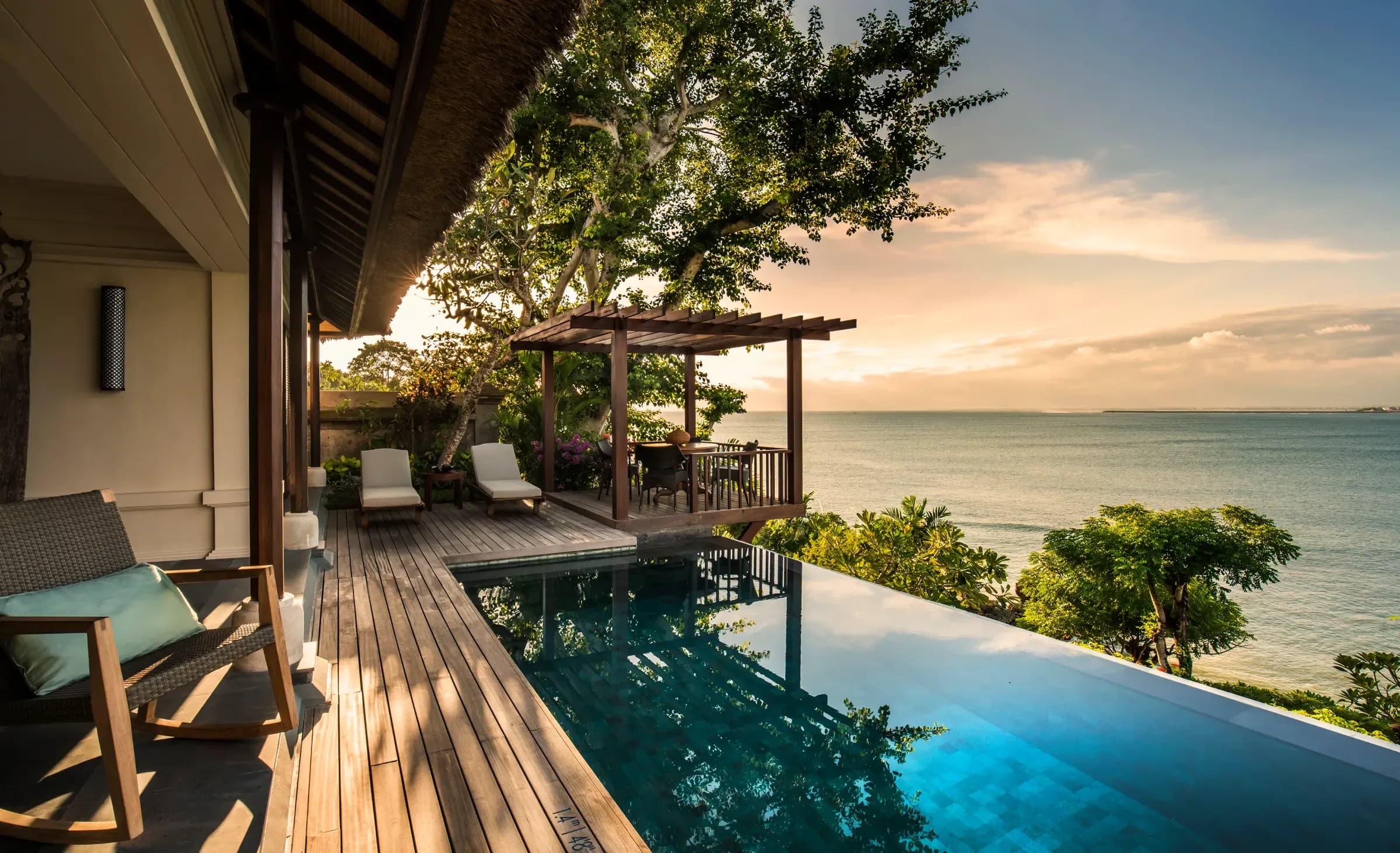 Private villa pool at Four Seasons Bali at Jimbaran Bay overlooking the ocean at sunset