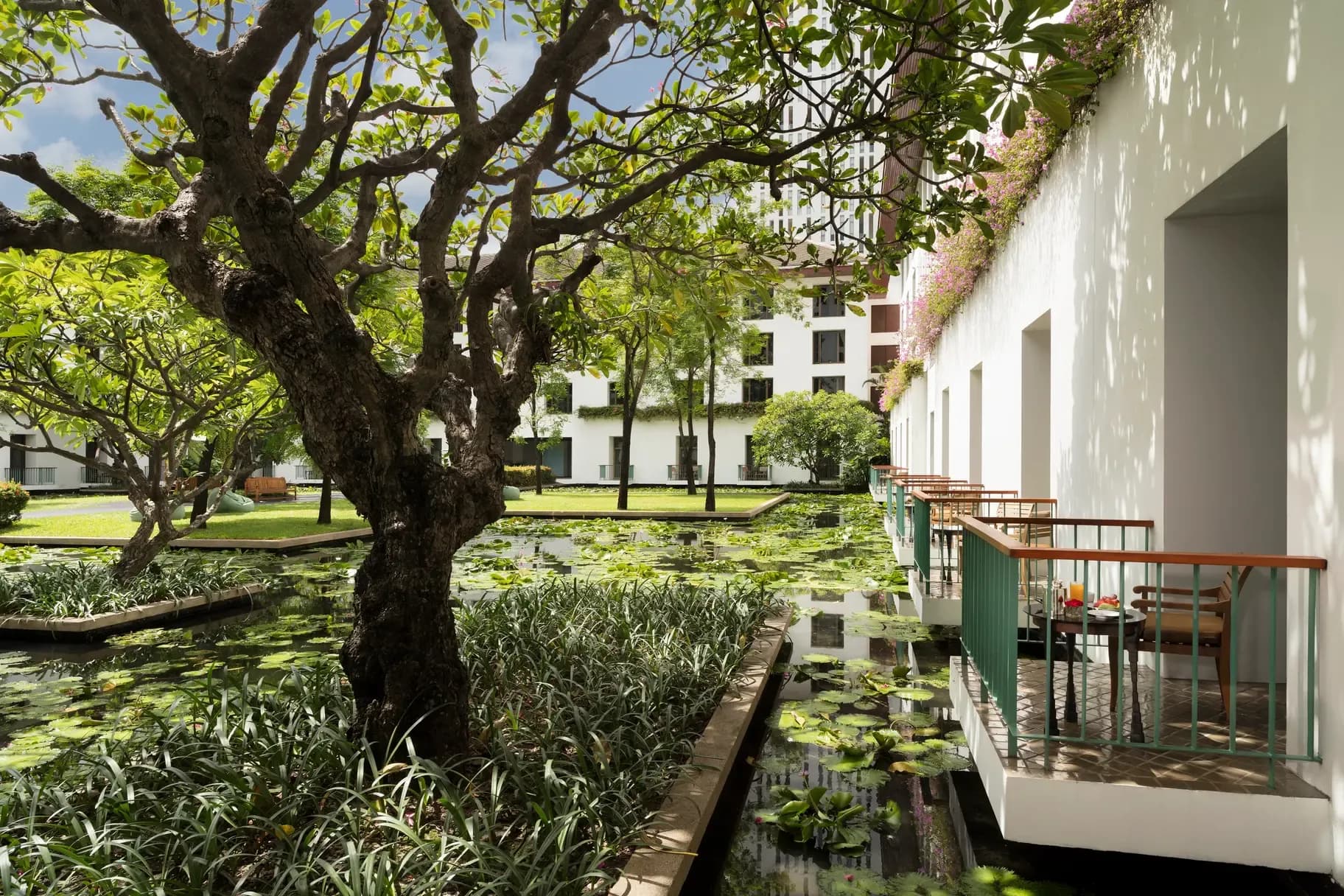 Reflecting lily ponds and the colonnaded courtyard terrace at The Sukhothai Bangkok on South Sathorn Road.
