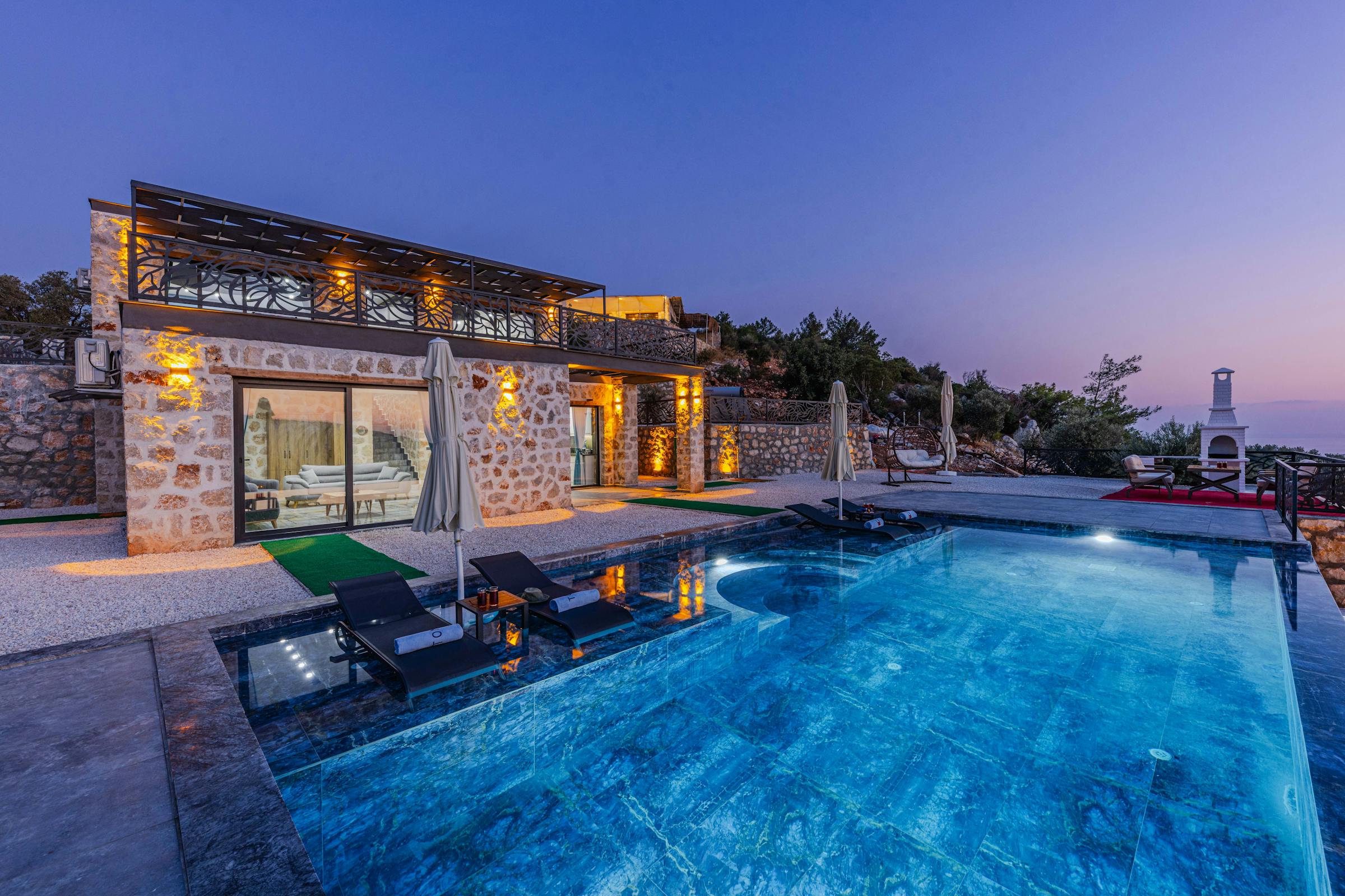 Stone villa and pool at twilight